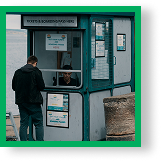 Man Standing in Front of a Booth
